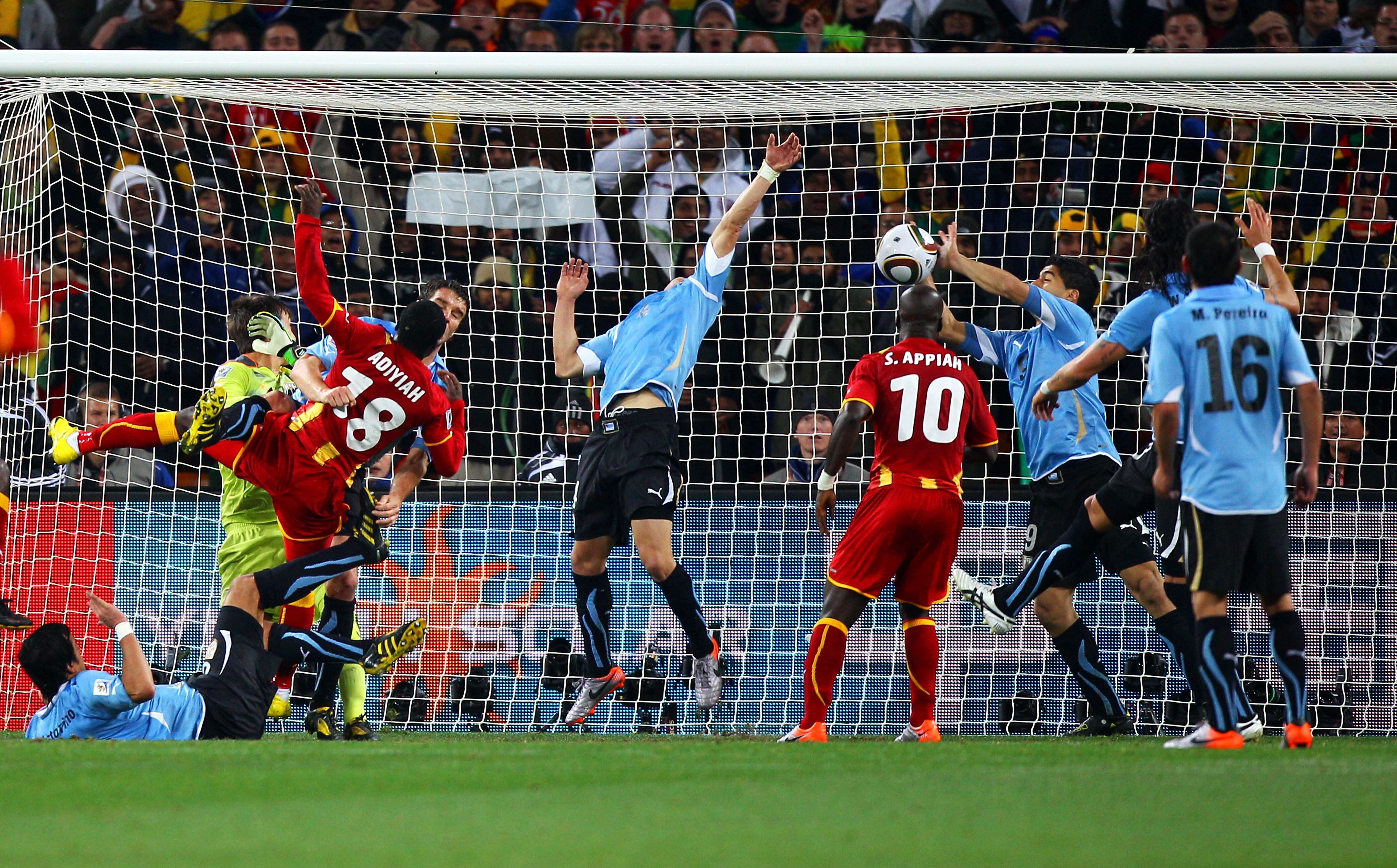 JOHANNESBURG, SOUTH AFRICA - JULY 02:  Luis Suarez of Uruguay handles the ball on the goal line, for which he is sent off, during the 2010 FIFA World Cup South Africa Quarter Final match between Uruguay and Ghana at the Soccer City stadium on July 2, 2010 in Johannesburg, South Africa.  (Photo by Michael Steele/Getty Images)