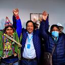 Bolivia's leftist presidential candidate Luis Arce (C), of the Movement for Socialism party, celebrates with running mate David Choquehuanca (R) early on October 19, 2020, in La Paz, Bolivia. - Bolivian presidential candidate Luis Arce, the leftist heir to former leader Evo Morales, appeared headed to a first-round election victory on October 18, 2020 with 52.4 percent of the vote, according to an authoritative exit poll from TV station Unitel. (Photo by RONALDO SCHEMIDT / AFP)