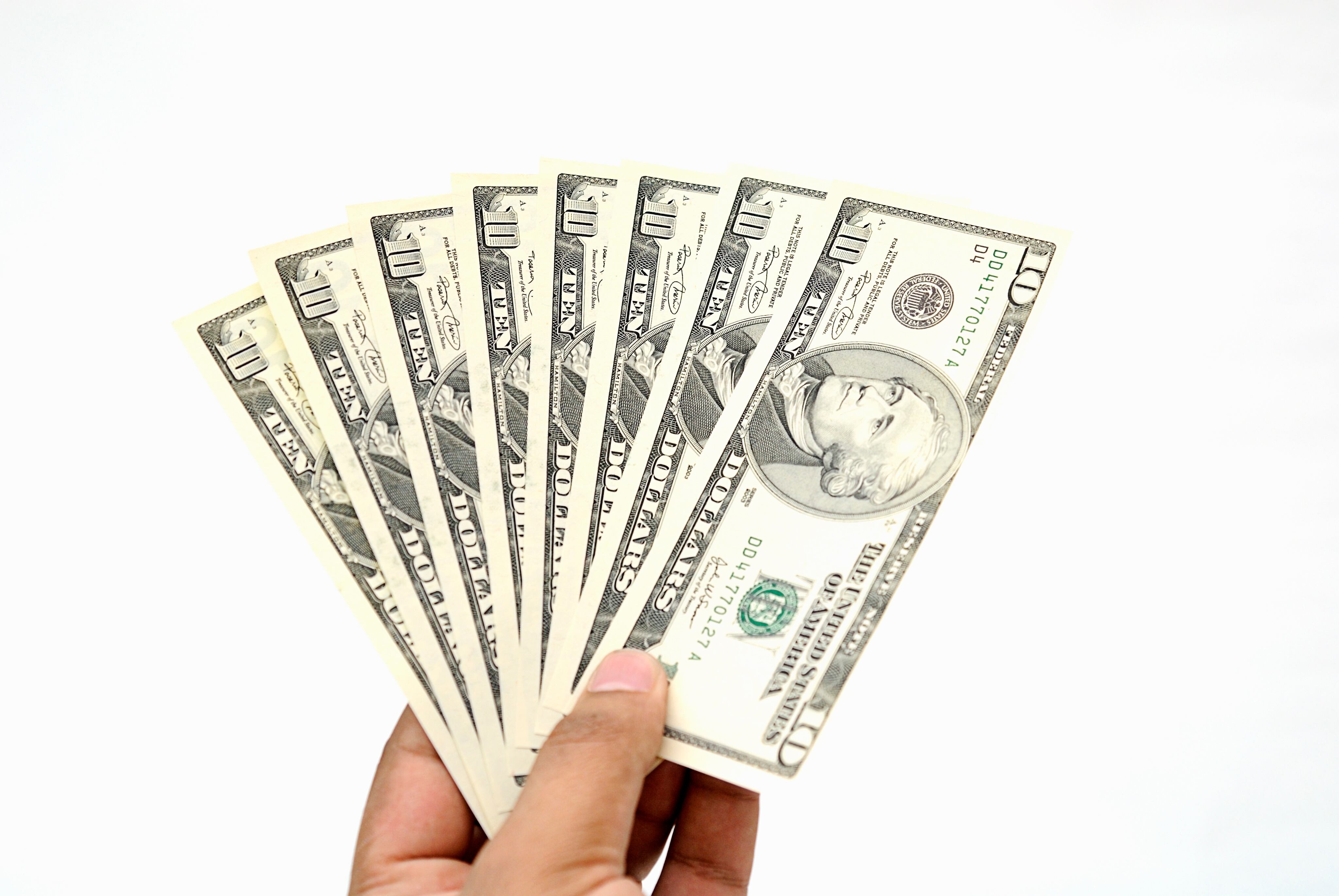 Hand holding American dollars.