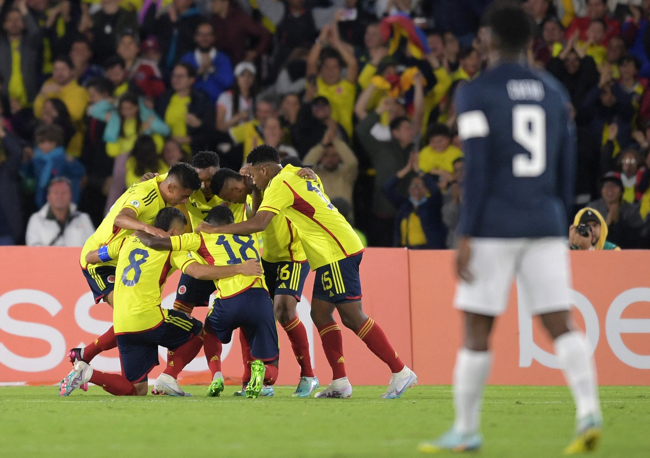 Colombian players celebrate after Ecuador scored an own goal during the South American U-20 championship football match at El Campin stadium in Bogota, Colombia on February 6, 2023. (Photo by DANIEL MUNOZ / AFP)