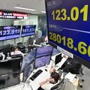 An electronic quotation board (front R) displays the yen's rate against the US dollar and the share price of the Tokyo Stock Exchange (bottom) at a foreign exchange brokerage in Tokyo on March 28, 2022. (Photo by Kazuhiro NOGI / AFP)