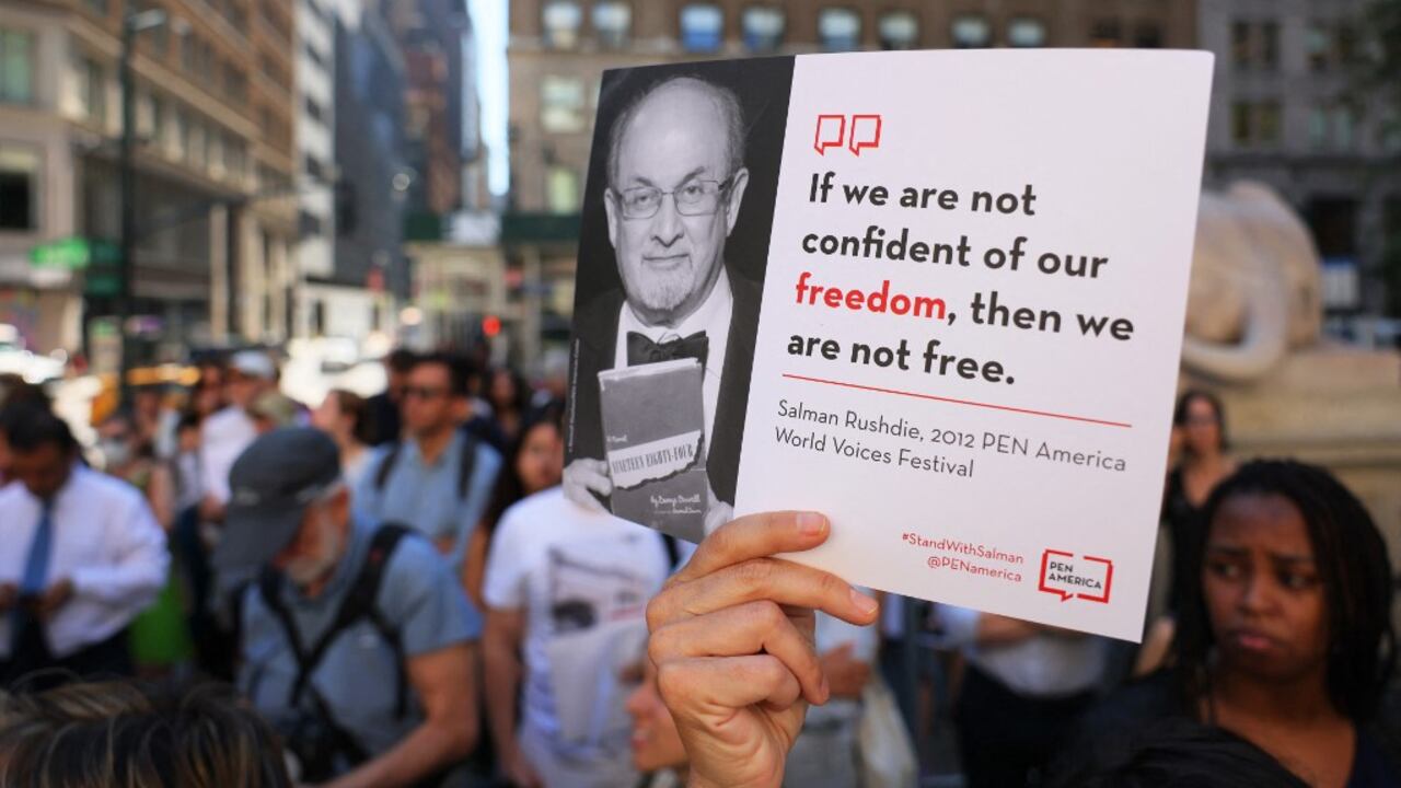 Las personas sostienen carteles mientras se reúnen en los escalones de la Biblioteca Pública de Nueva York para mostrar su apoyo a Salman Rushdie el 19 de agosto de 2022 en la ciudad de Nueva York. La comunidad literaria de Nueva York se reunió en la Biblioteca Pública de Nueva York en solidaridad con Salman Rushdie una semana después de que fuera atacado y apuñalado varias veces mientras daba una charla en la Institución Chautauqua. Su atacante se declaró inocente el jueves de los cargos de intento de asesinato en segundo grado y asalto en segundo grado. Michael M. Santiago/Getty Images/AFP (Foto de Michael M. Santiago / GETTY IMAGES NORTH AMERICA / Getty Images vía AFP)