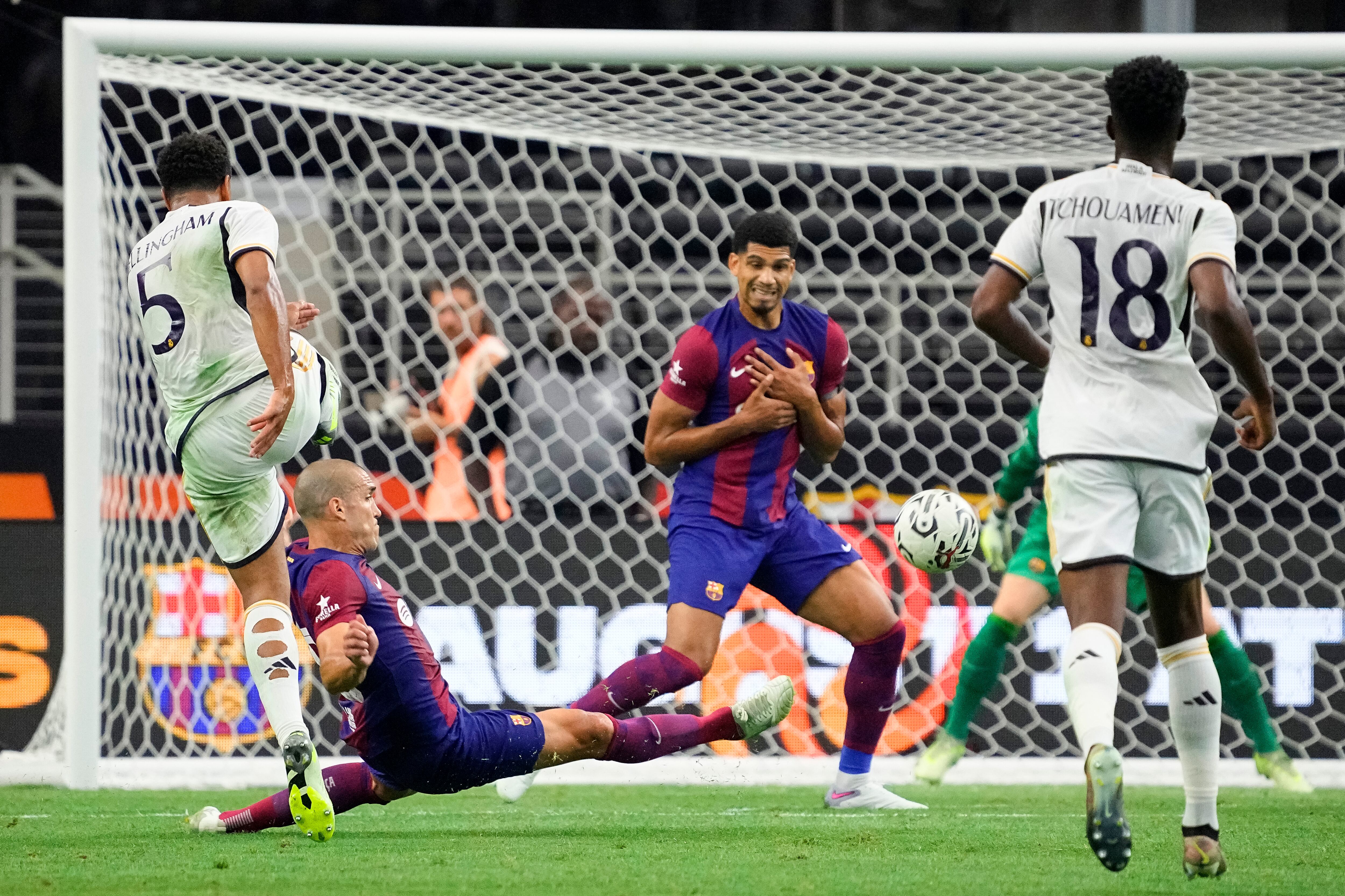 ARLINGTON, TEXAS - JULY 29: Oriol Romeu #18 of FC Barcelona slides to block a shot from Jude Bellingham #5 of Real Madrid during the first half of the pre-season friendly match at AT&T Stadium on July 29, 2023 in Arlington, Texas. (Photo by Sam Hodde/Getty Images)