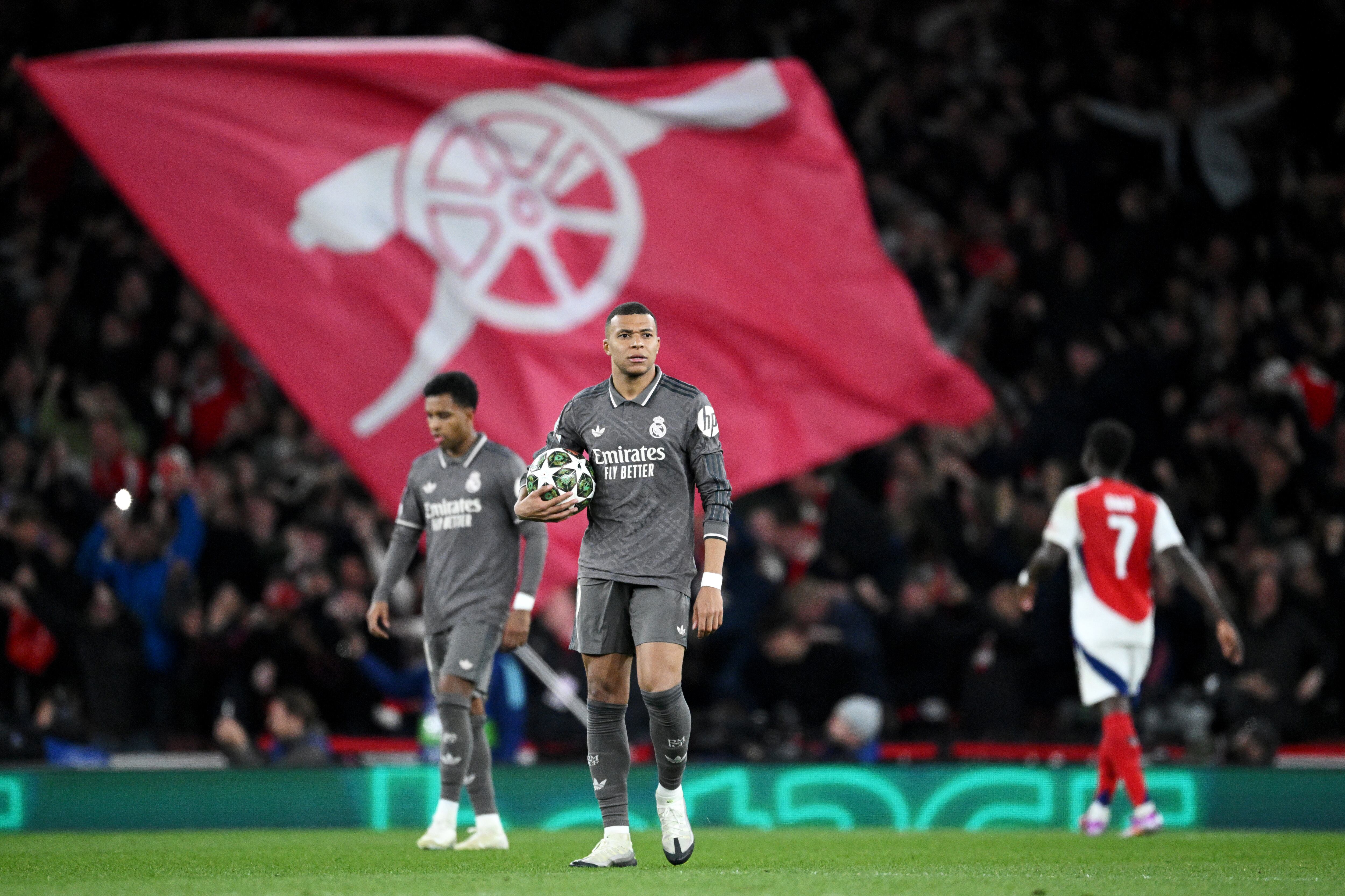 LONDON, ENGLAND - APRIL 08: Kylian Mbappe of Real Madrid holds the ball as he prepares to restart play after Declan Rice of Arsenal (not pictured) scores his team's second goal during the UEFA Champions League 2024/25 Quarter Final First Leg match between Arsenal FC and Real Madrid C.F. at Emirates Stadium on April 08, 2025 in London, England. (Photo by Justin Setterfield/Getty Images)