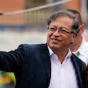 Gustavo Petro, left, presidential candidate with the Historical Pact coalition, waves upon his arrival to a polling station to vote in presidential elections in Bogota, Colombia, Sunday, May 29, 2022. (AP Photo/Fernando Vergara)