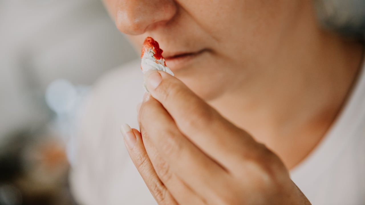 Woman wiping her bleeding nose with tissue