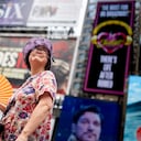 A tour guide fans herself while working in Times Square as temperatures rise, Thursday, July 27, 2023, in New York. Swaths of the United States are sweltering under an onslaught of searing temperatures. Around one-third of Americans are under some type of heat advisory. (AP Photo/John Minchillo)