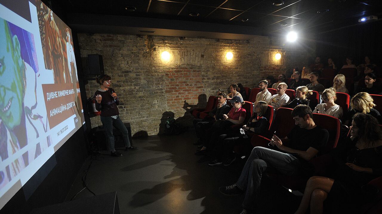 Members of the pubic watch 'Odd, Bizarre and Fantastic", a Ukrainian 1980s/1990s animation showcase, in KINO24 in Kyiv, on July 14, 2022. (Photo by SERGEI CHUZAVKOV / AFP)