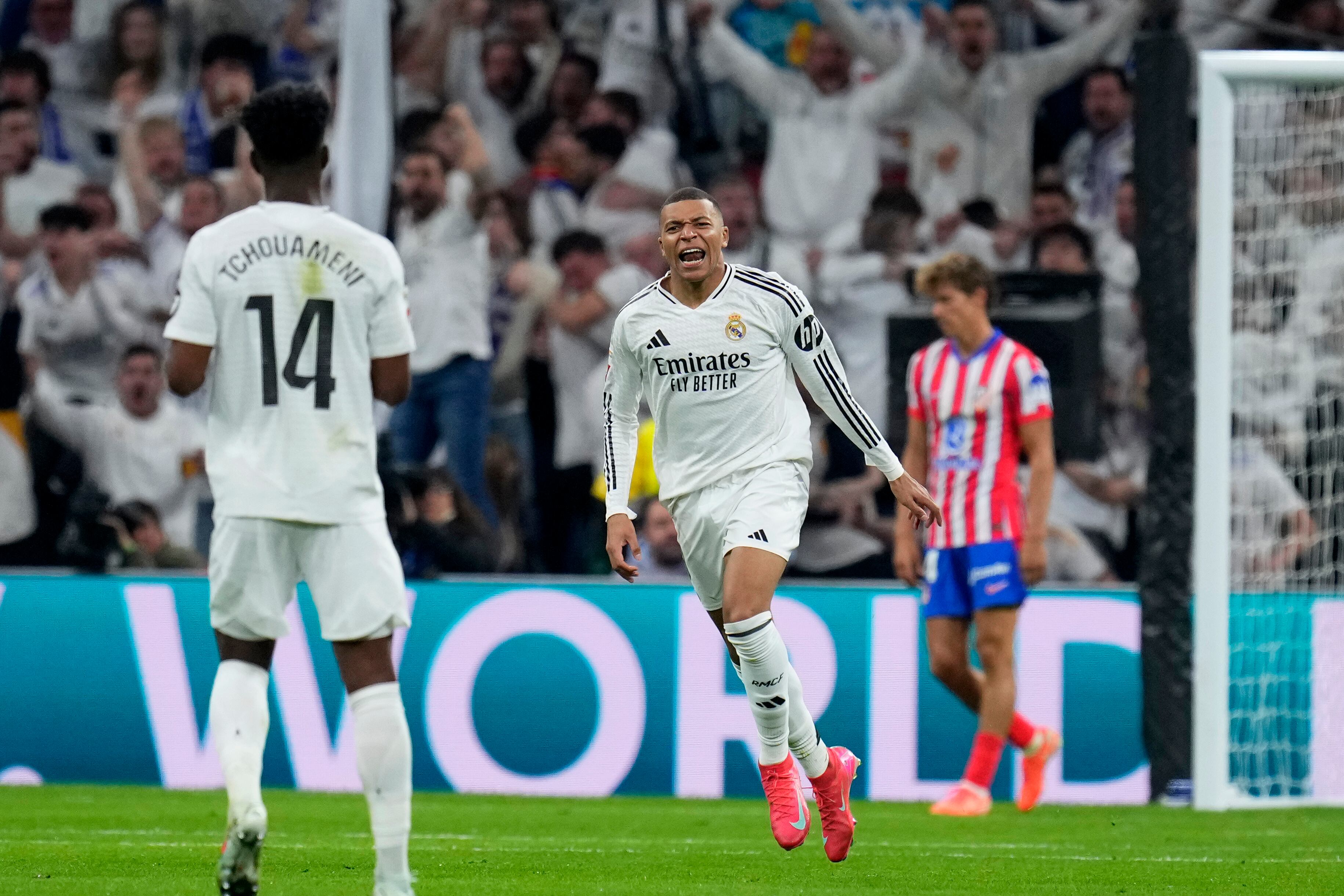 Real Madrid's Kylian Mbappe, center, celebrates after scoring his side's first goal during a Spanish La Liga soccer match between Real Madrid and Atletico Madrid at the Santiago Bernabeu stadium in Madrid, Saturday, Feb. 8, 2025. (AP Photo/Manu Fernandez)