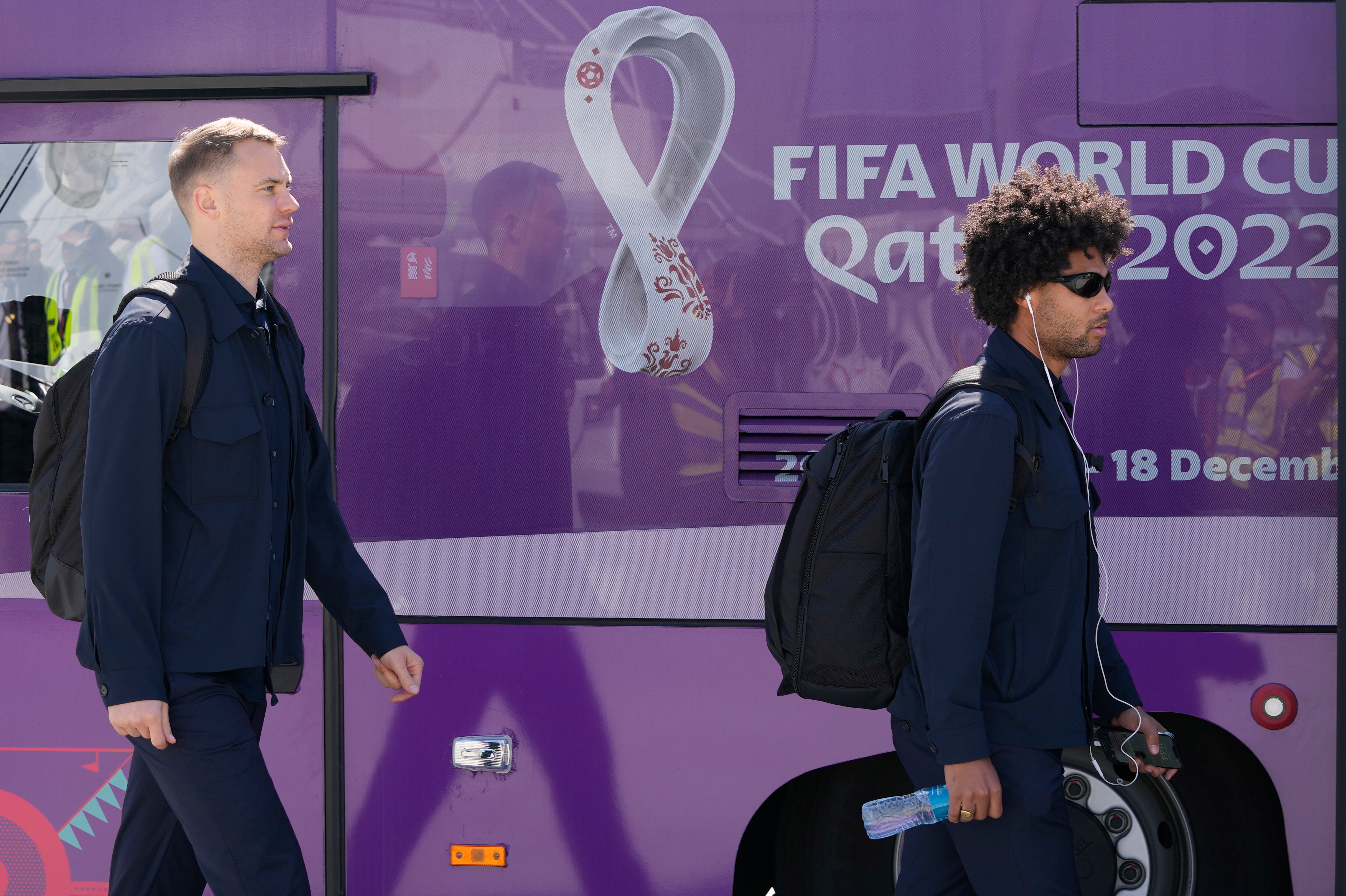 Manuel Neuer, left, and Serge Gnabry of Germany's national soccer team arrive with teammates at Hamad International airport in Doha, Qatar, Thursday, Nov. 17, 2022 ahead of the upcoming World Cup. Germany will play the first match in the World Cup against Japan on Nov. 23. (AP Photo/Hassan Ammar)
