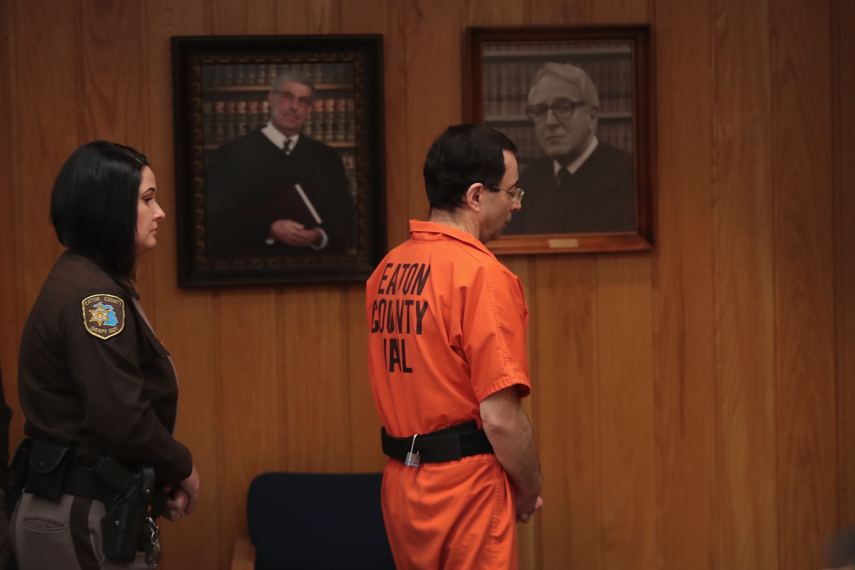 CHARLOTTE, MI - FEBRUARY 05:  Larry Nassar is led from the courtroom after being sentenced by Judge Janice Cunningham to 40 to 125 years in prison for three counts of criminal sexual assault in Eaton County Circuit Court on February 5, 2018 in Charlotte, Michigan. Nassar has been accused of sexually assaulting more than 150 girls and young women while he was a physician for USA Gymnastics and Michigan State University. He is currently serving a 60-year sentence in federal prison for possession of child pornography. Last month a judge in Ingham County, Michigan sentenced Nassar to an 40 to 175 years in prison after he plead guilty to sexually assaulting seven girls.  (Photo by Scott Olson/Getty Images)