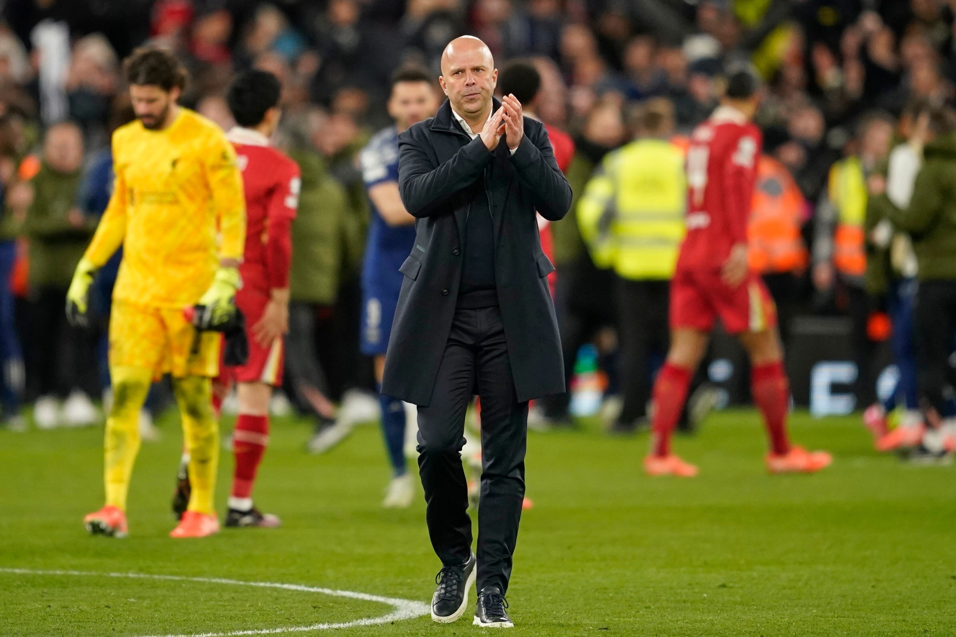 Liverpool's manager Arne Slot applauds the crowd after his team lost a penalty shootout at the end of the Champions League round of 16 second leg soccer match between Liverpool and Paris Saint-Germain at Anfield in Liverpool, England, Tuesday, March 11, 2025. (AP Photo/Dave Thompson)