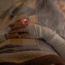An injured Ukrainian soldier lies in a bed onboard a military evacuation train transporting Ukrainian servicemen wounded in frontline areas to hospitals, in an undisclosed location, on October 18, 2024, amid the Russian invasion of Ukraine. The train evacuations in Ukraine began when the war did, in February 2022, reviving process used in World War II, and now several refitted trains take wounded troops from the front. Nearly three years after Russian forces invaded Ukraine, many medical facilities in war-battered eastern Ukraine have been damaged or destroyed, and those untouched are overcrowded. For Oleksandr, the military doctor overseeing the evacuation, there are clear benefits to rail: many people can be moved at once and its safer than transporting wounded soldiers by helicopter, given Russian superiority in Ukraine's airspace. But there are risks too, he said. "Our adversary in the war does not distinguish between what's medical and military, so we take certain security measures". (Photo by Roman PILIPEY / AFP)