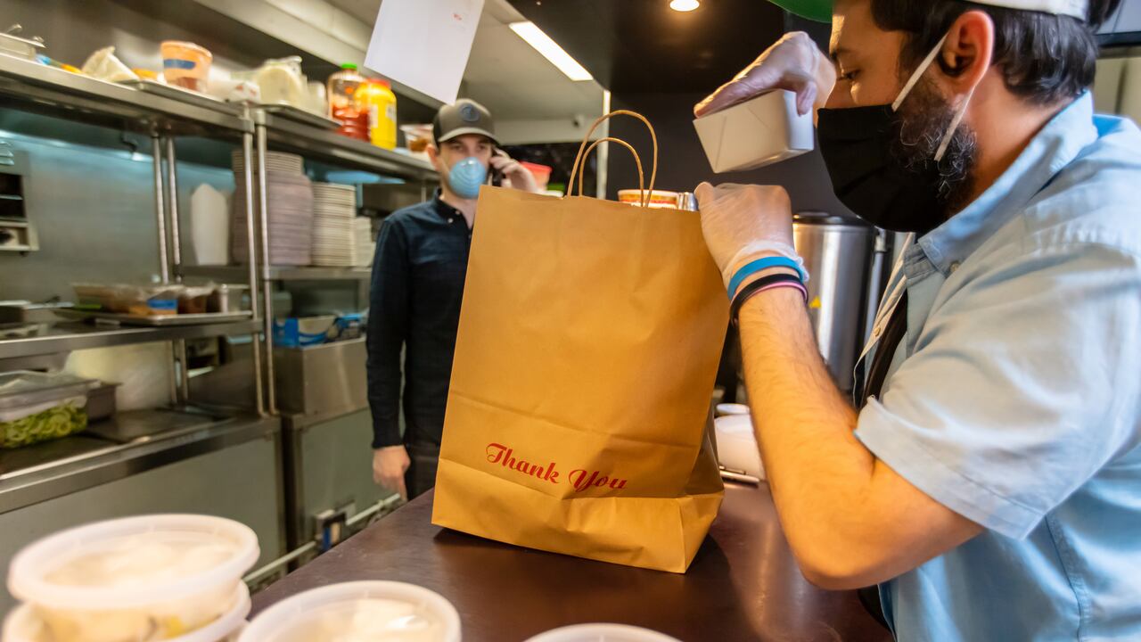A restaurant adapts to the Covid-19 pandemic and stay at home orders by pivoting to take out and delivery.