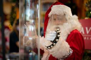Se ven gotas de sudor en el protector facial de un hombre vestido con un traje de Santa Claus, en medio de las preocupaciones por la propagación del coronavirus COVID-19, en un centro comercial con adornos navideños en Kuala Lumpur, Malasia. Foto: AP / Vincent Thian.