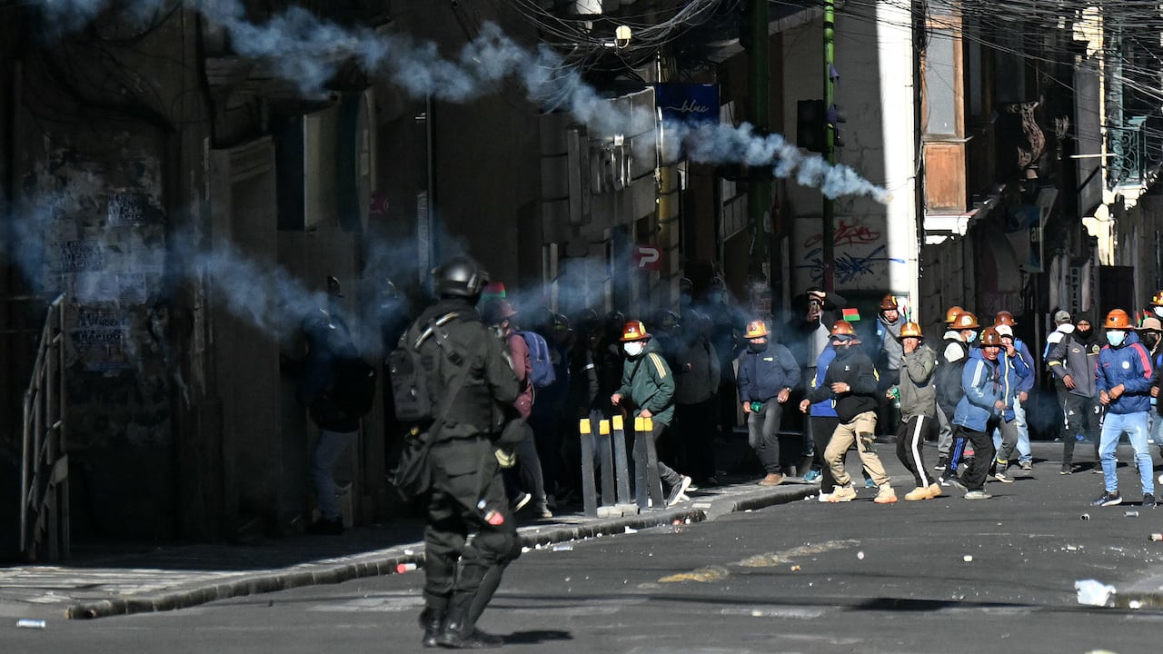 Un agente antidisturbios lanza gases lacrimógenos contra mineros durante una marcha para exigir la renuncia del presidente boliviano Rodrigo Paz, en La Paz, el 14 de mayo de 2026. Durante las últimas dos semanas, trabajadores, campesinos, maestros, grupos indígenas y trabajadores del transporte han estado presionando al gobierno. Sus demandas van desde aumentos salariales y estabilización económica hasta la oposición a la privatización de empresas públicas.
