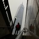 A commuter steps into the subway as smoke from wildfires in Canada partially obscure One World Trade Center in lower Manhattan, Tuesday, June 6, 2023, in New York. (AP Photo/Daniel P. Derella)