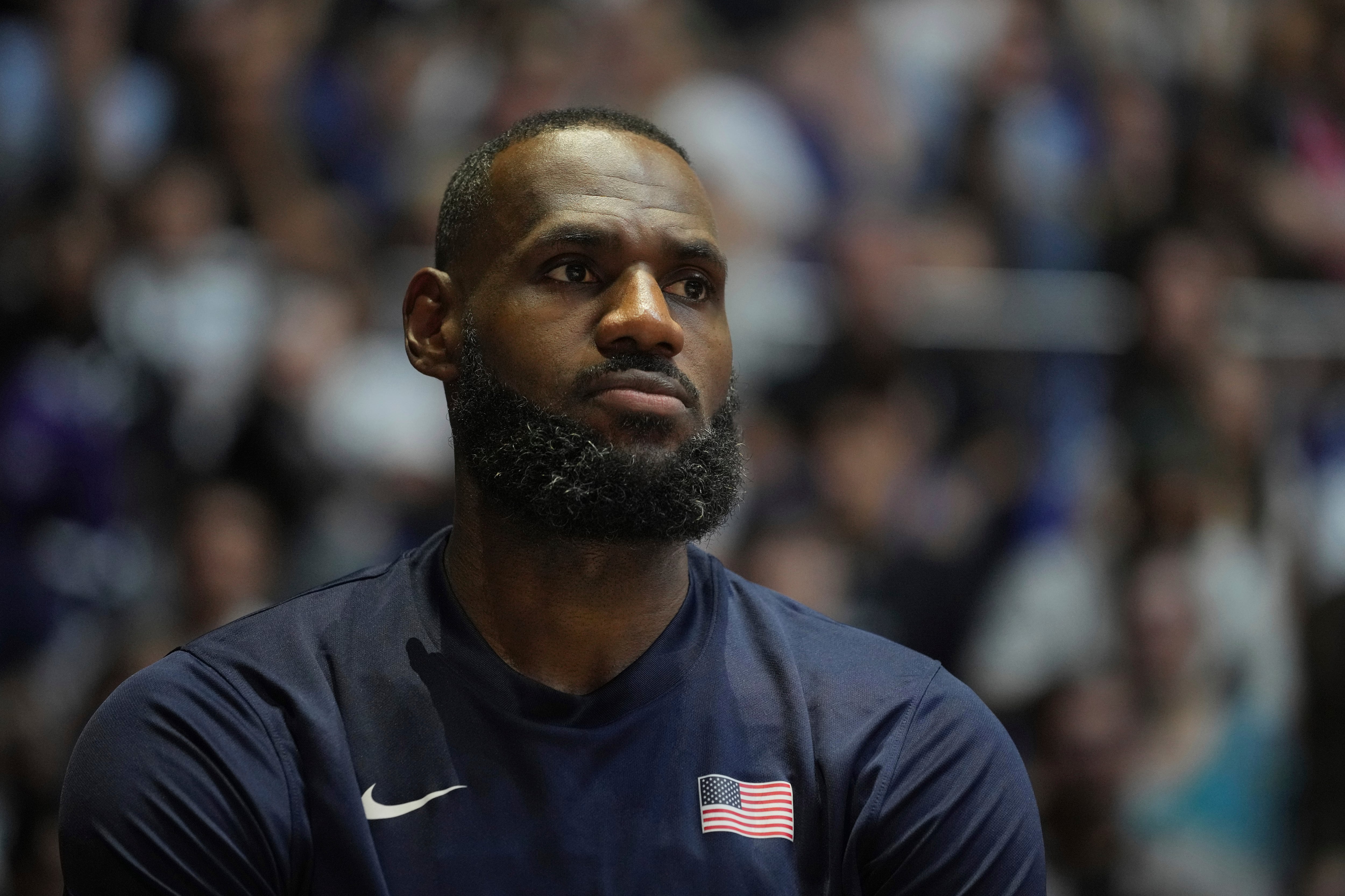 United States' forward LeBron James watches his teammates play during an exhibition basketball game between the United States and South Sudan, at the o2 Arena in London, Saturday, July 20, 2024. (AP Photo/Kin Cheung)