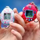 PARIS, FRANCE - OCTOBER 25: Children show their "Tamagotchi" electronic pet on October 25, 2017 in Paris, France. Tamagotchi is a virtual electronic animal which means "cute little egg" and simulates the life of an animal. Twenty years after its creation, the Japanese company Bandai reissues the famous limited edition toy that is available today in France. Tamagotchi will be available in the United States on November 5, 2017. (Photo by Chesnot/Getty Images)