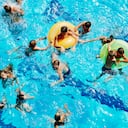Group of kids playing together in outdoor pool overhead view