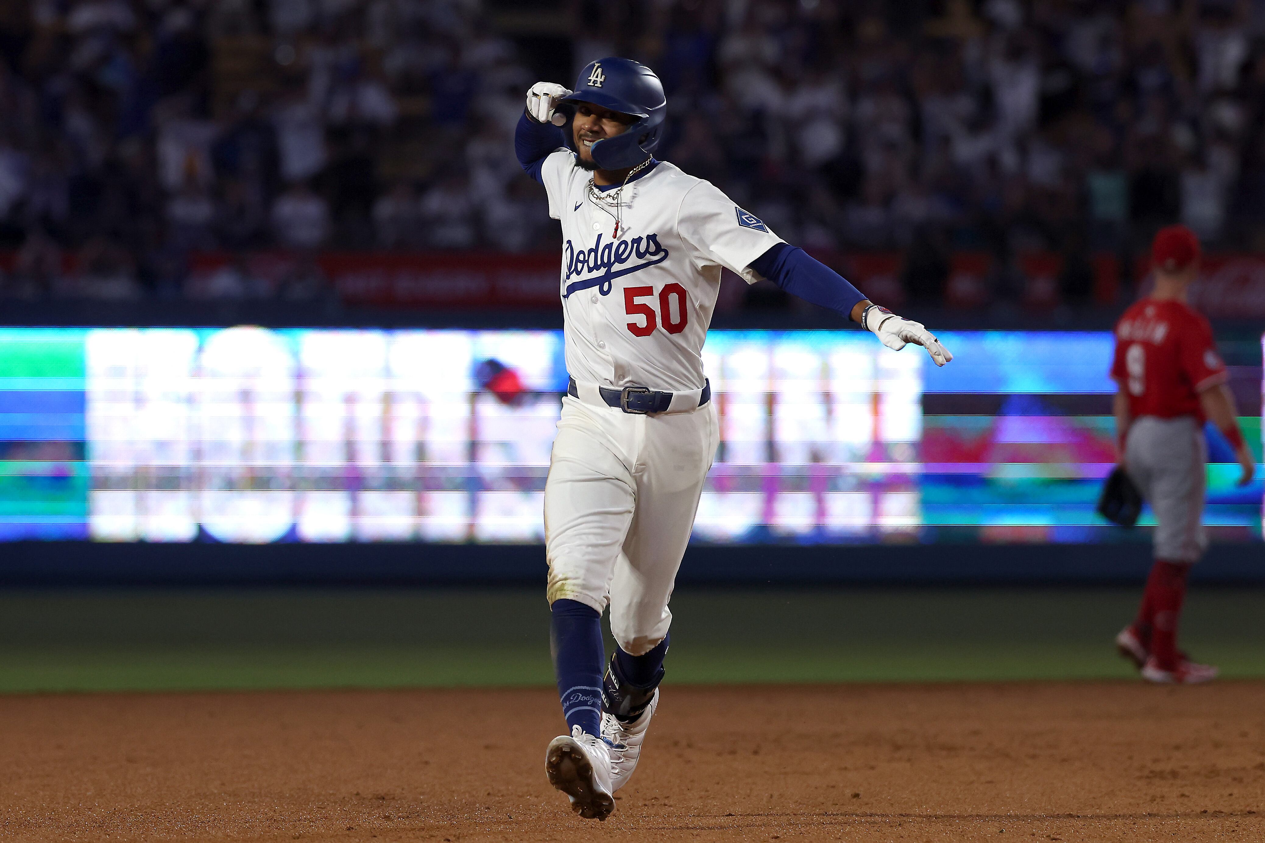 LOS ANGELES, CALIFORNIA - AUGUST 25: Mookie Betts #50 of the Los Angeles Dodgers celebrates his home run during the seventh inning against the Cincinnati Reds at Dodger Stadium on August 25, 2025 in Los Angeles, California. (Photo by Katelyn Mulcahy/Getty Images)