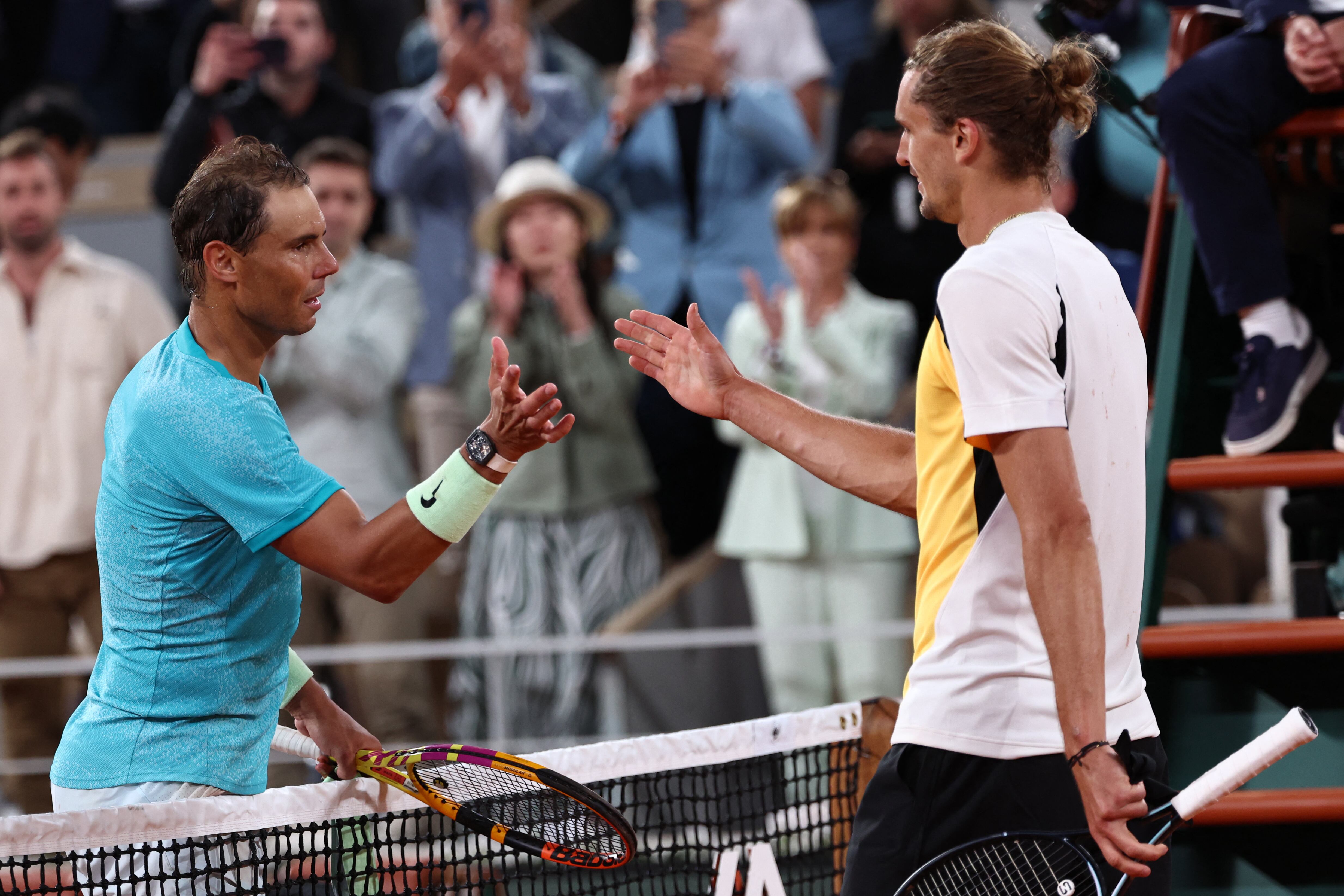 Spain's Rafael Nadal checks hands with the winner Germany's Alexander Zverev after their men's singles match on Court Philippe-Chatrier on day two of the French Open tennis tournament at the Roland Garros Complex in Paris on May 27, 2024. (Photo by EMMANUEL DUNAND / AFP)