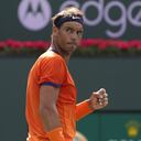FILE - Rafael Nadal, of Spain, celebrates winning a game against Carlos Alcaraz, of Spain, during their men's singles semifinals at the BNP Paribas Open tennis tournament, March 19, 2022, in Indian Wells, Calif. Nadal on Tuesday, April 26 that he will play the Madrid Open after recovering from a rib injury that sidelined him for a month. The Madrid Open starts Friday, April 29. (AP Photo/Mark J. Terrill, file)