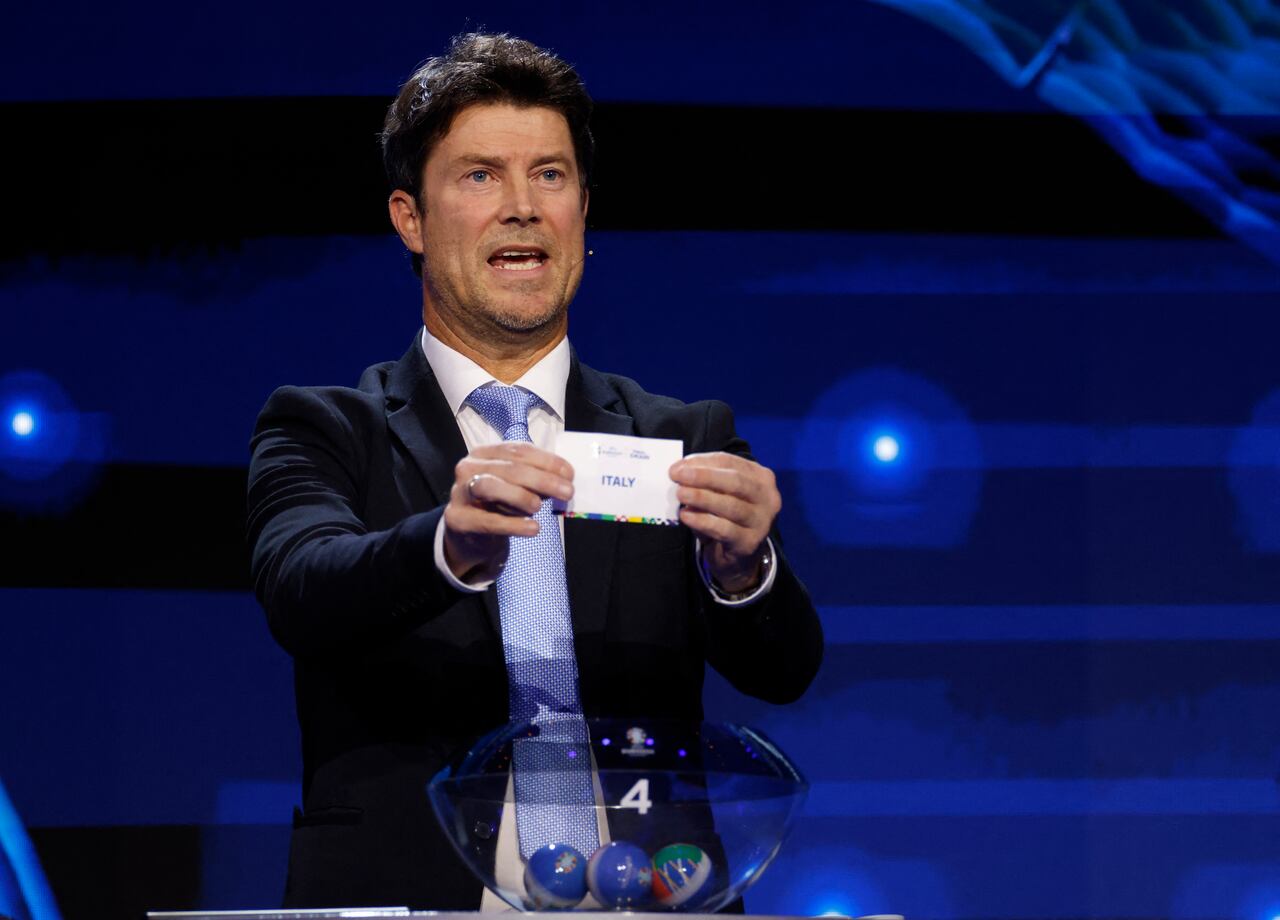 Danish Former footballer Brian Laudrup holds up a slip of paper after drawing Italy from the pot during the final draw for the UEFA Euro 2024 European Championship football competition in Hamburg, northern Germany on December 2, 2023. (Photo by Odd ANDERSEN / AFP)