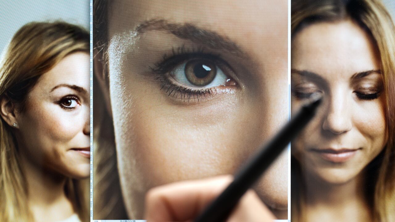 Image of a hand with professional digital tablet retouching and editing multiple digital photographs of a beautiful woman. Sharp focus on screen. Horizontal image from a DSLR camera.