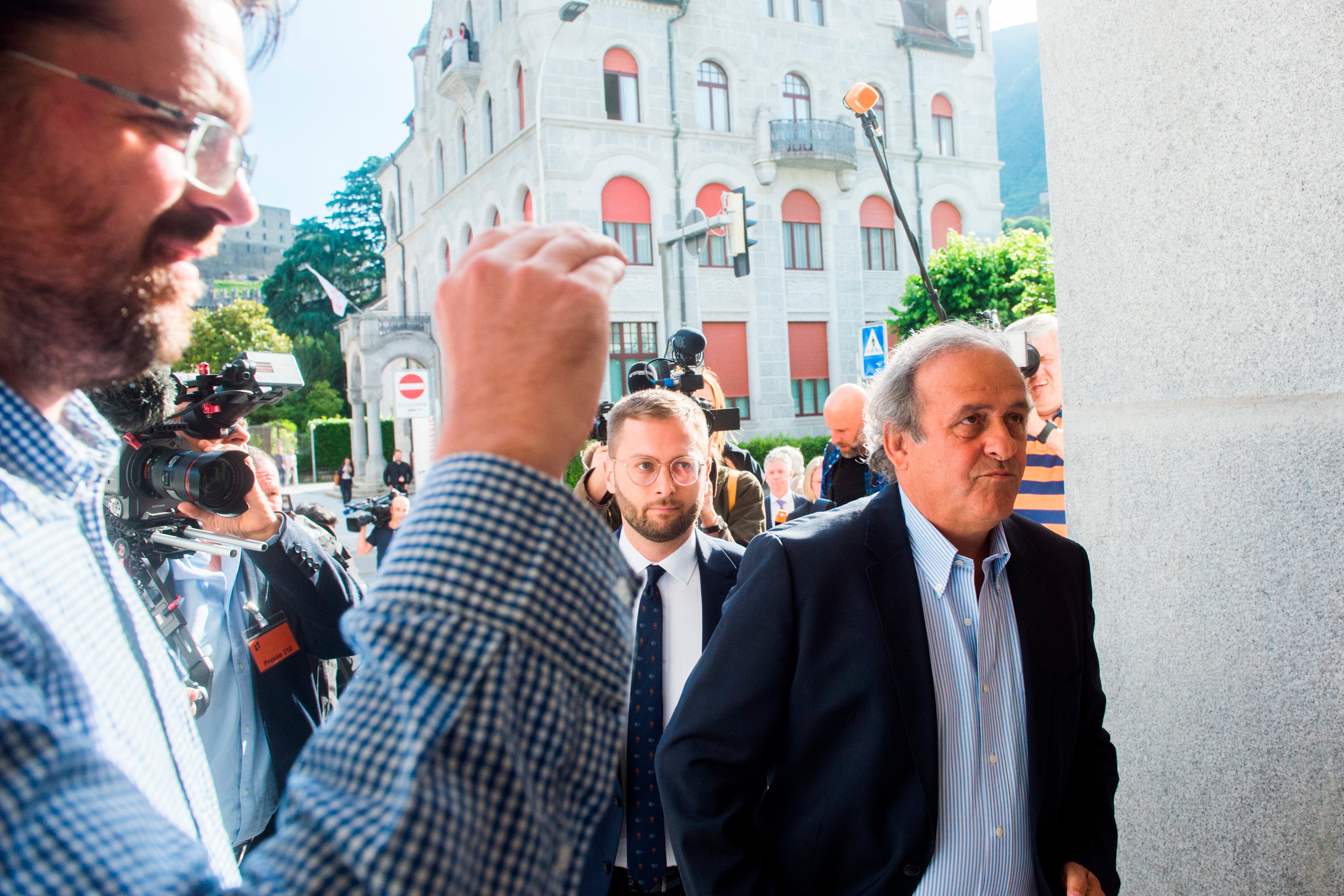The former president of the the European Football Association (UEFA), Michel Platini, right, arrives at the Swiss Federal Criminal Court in Bellinzona, Switzerland, Wednesday, June 8, 2022. Platini and the former president of the World Football Association (Fifa), Joseph Blatter, will stand trial before the Federal Criminal Court from Wednesday, over a suspicious two-million payment. (Alessandro Crinari/Keystone via A