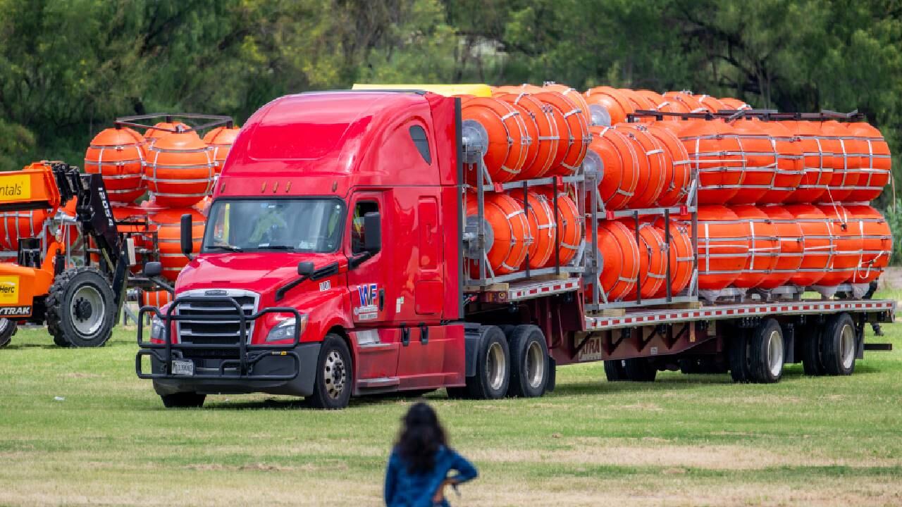 Una mujer inspecciona la preparación de la instalación de una barrera de boyas el 7 de julio de 2023 en Eagle Pass, Texas.