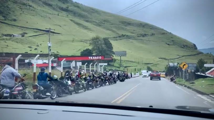 De un lado la fila de motos y de otro lado la fila de carros en busca de gasolina.