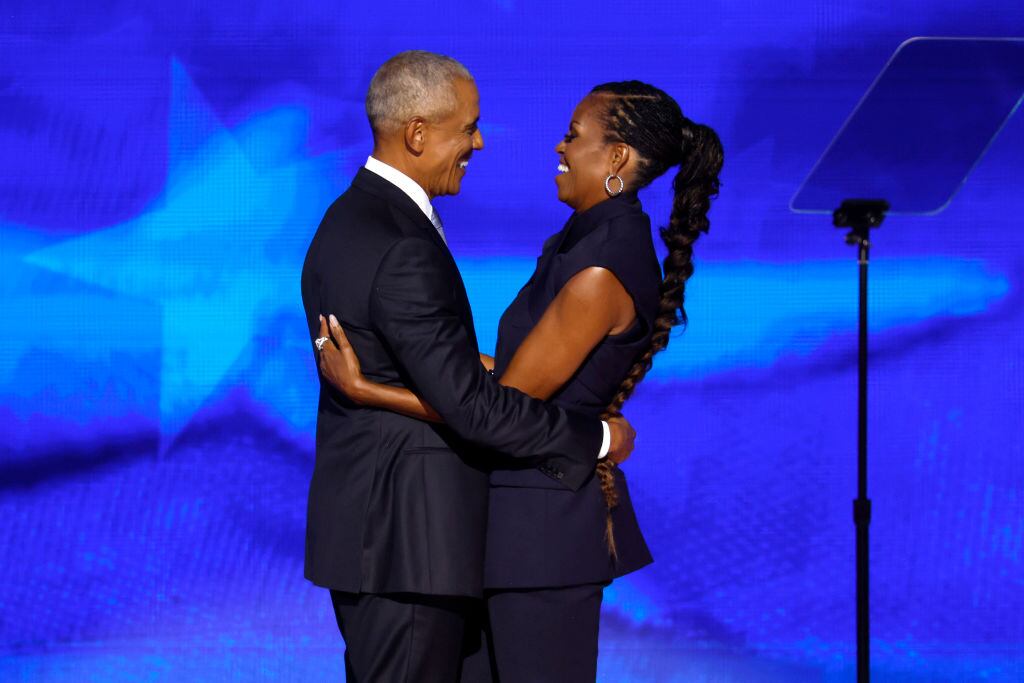 CHICAGO, ILLINOIS - AUGUST 20: Former U.S. President Barack Obama (L) greets former first lady Michelle Obama as he arrives to speak on stage during the second day of the Democratic National Convention at the United Center on August 20, 2024 in Chicago, Illinois. Delegates, politicians, and Democratic Party supporters are gathering in Chicago, as current Vice President Kamala Harris is named her party's presidential nominee. The DNC takes place from August 19-22. (Photo by Chip Somodevilla/Getty Images)