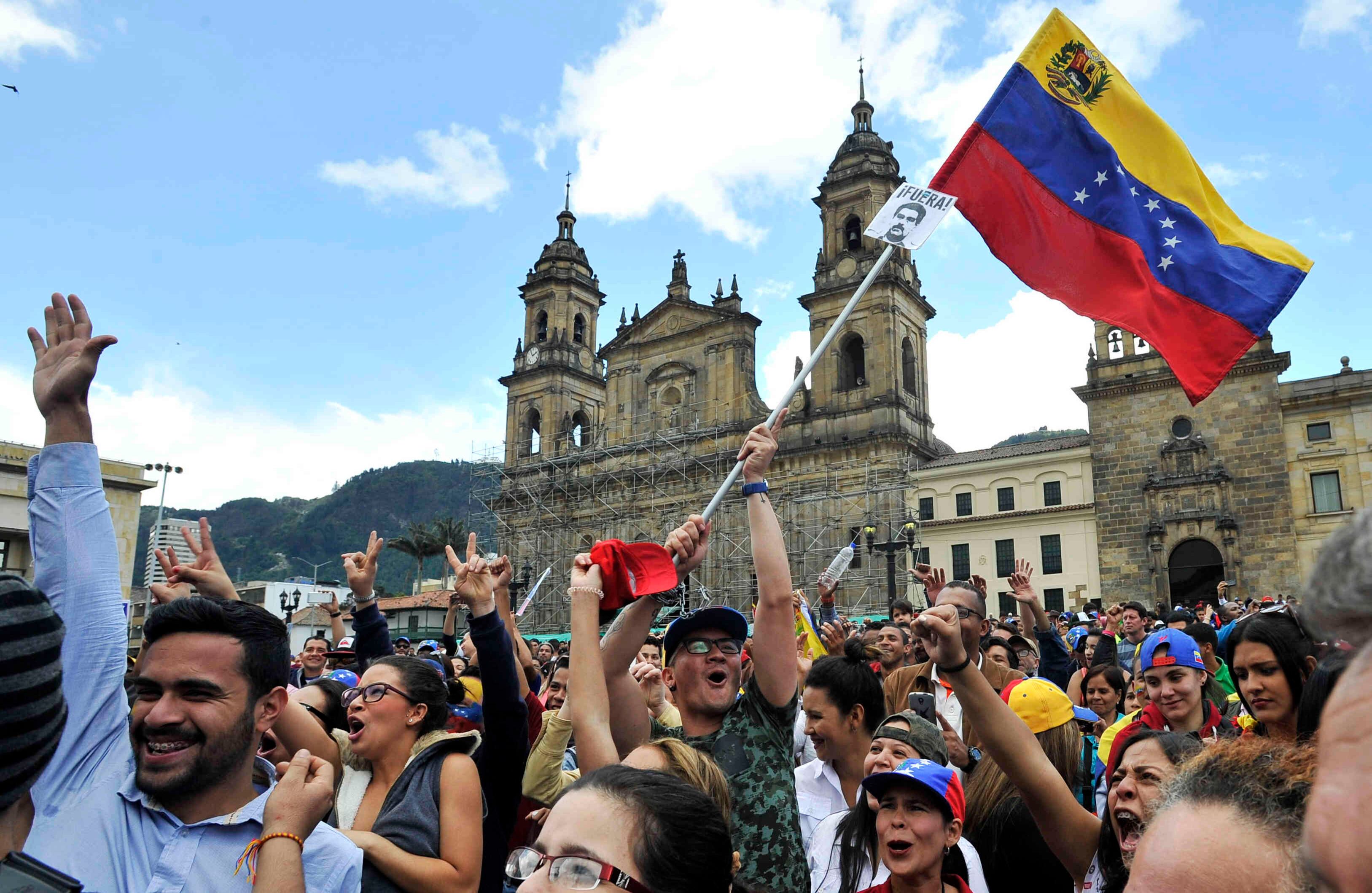 . Ciudadanos venezolanos —residentes en Bogotá— lanzan arengas luego de  sufragar en la Plaza de Bolívar,  el domingo 16 de julio de 2017, en Colombia, durante las votaciones al plebiscito. Esta jornada democrática ha sido  impulsada  por la oposición al gobierno de Nicolás Maduro. En las tarjetas, los ciudadanos deben responder ‘sí’ o ‘no’ a tres preguntas: la primera es si respalda el plan del presidente Nicolás Maduro de cambiar la Constitución; la segunda es si  apoya la intervención de las Fuerzas Armadas para “restituir el orden constitucional” y por último si desea un gobierno de unidad nacional. Foto: Carlos Julio Martínez / SEMANA