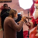 Un hombre vestido como Papá Noel entrega un obsequio a una mujer en un asilo de ancianos, en la ciudad de Nueva York.