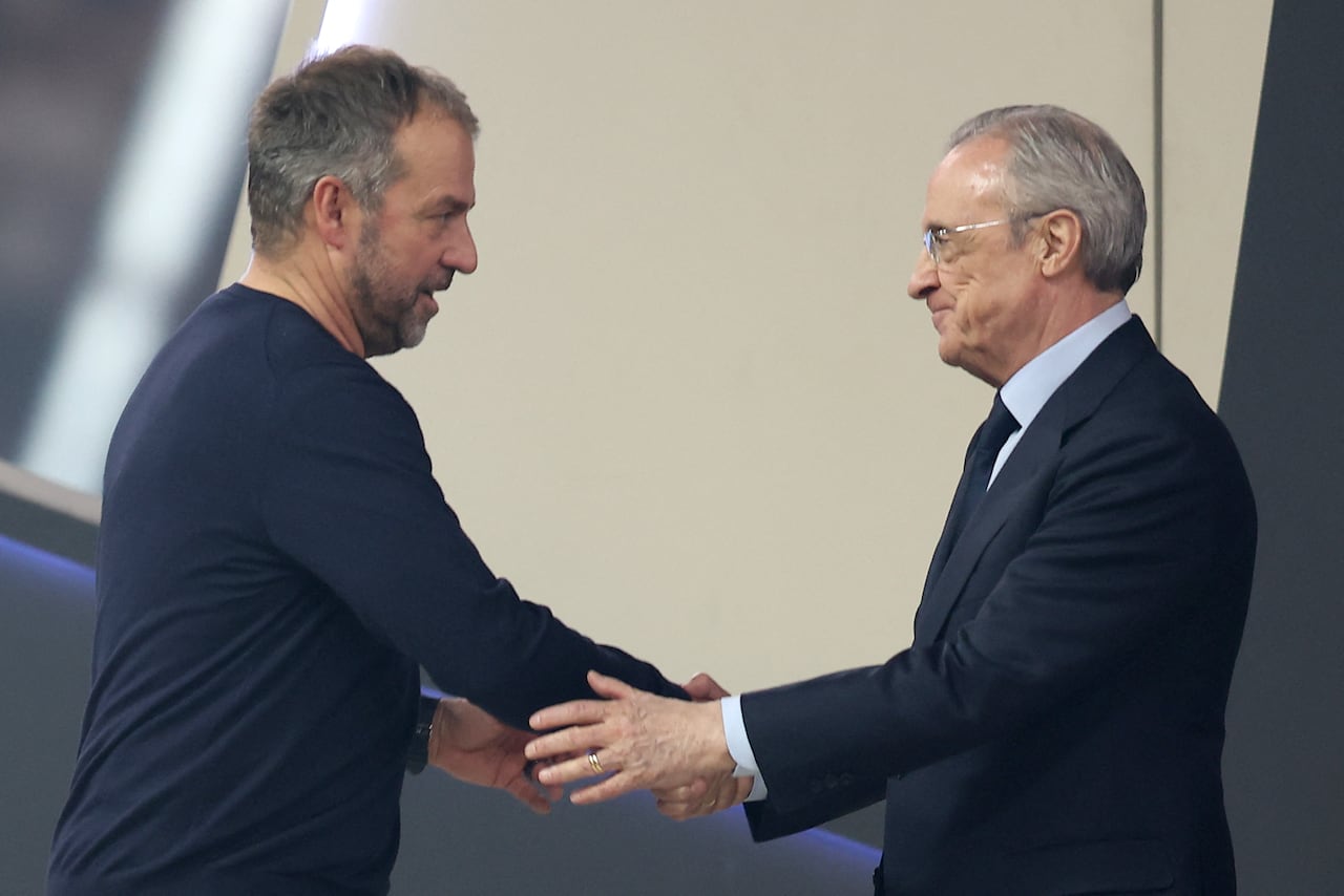 Real Madrid President Florentino Perez (R) shakes hands with Barcelona's German coach Hans-Dieter Flick at the end of the Spanish Super Cup final football match between Real Madrid and Barcelona at the King Abdullah Sport City in Jeddah on January 12, 2025. (Photo by Haitham AL-SHUKAIRI / AFP)