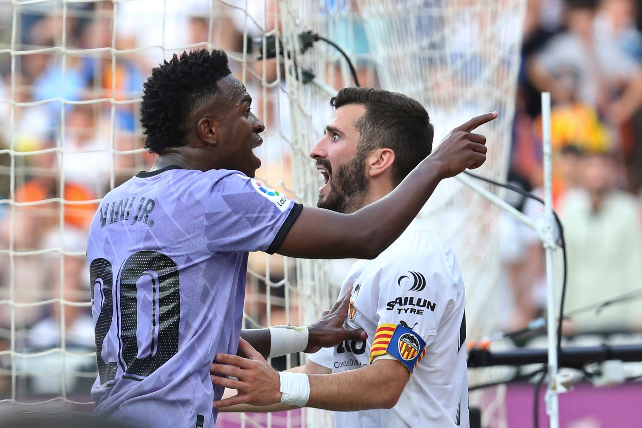 FILE - Real Madrid's Vinicius Junior, left, confronts Valencia fans standing in front of Valencia's Jose Luis Gaya during a Spanish La Liga soccer match between Valencia and Real Madrid, at the Mestalla stadium in Valencia, Spain, Sunday, May 21, 2023. Repeated racist insults against Brazilian soccer star Vincius Junior have unleashed a heated debate in Spain about tolerance for racism in a society that is becoming rapidly more diverse on and off the field. (AP Photo/Alberto Saiz, File)