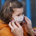 Child with protective face mask during COVID-19 pandemic