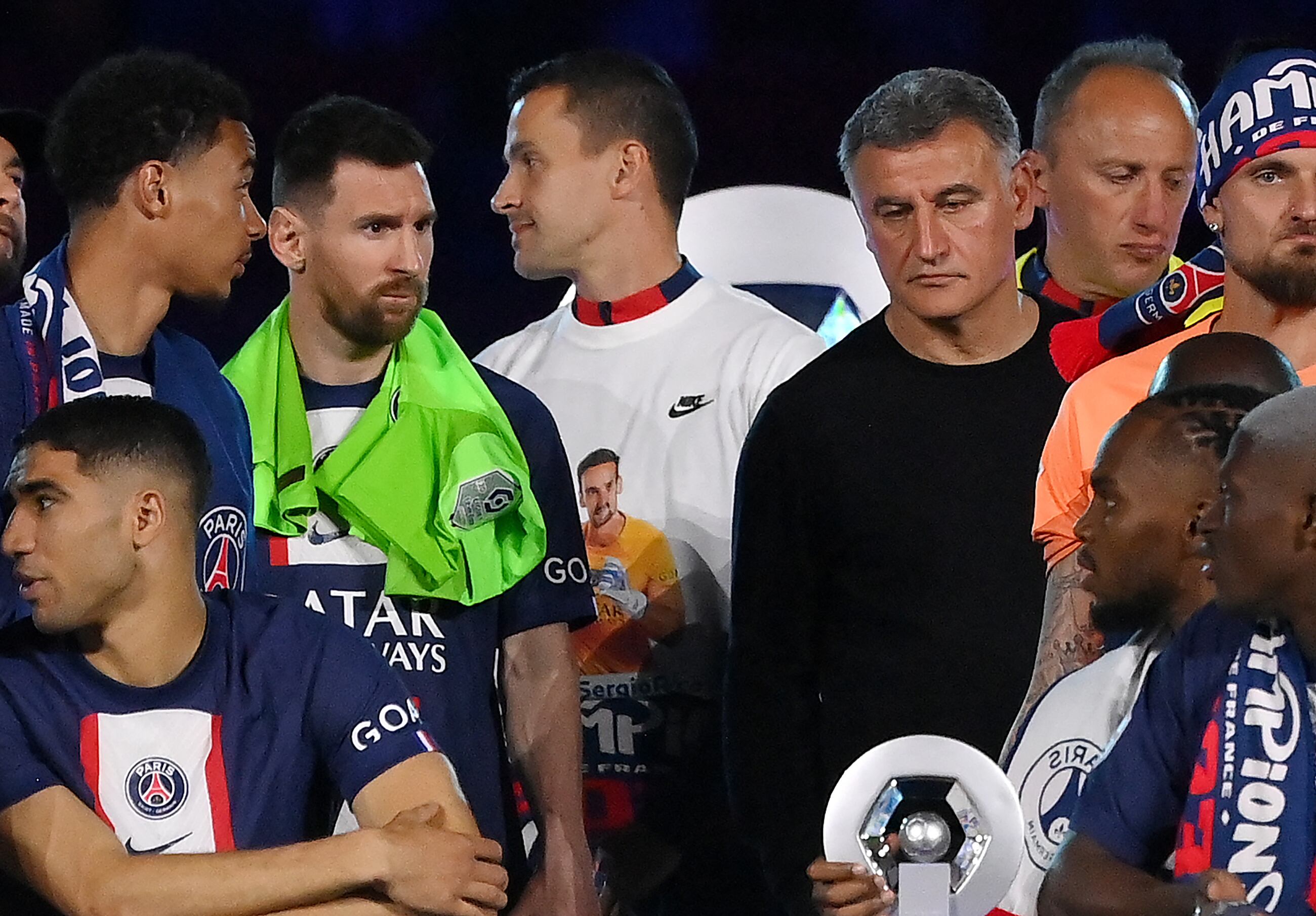 Paris Saint-Germain's Argentinian forward Lionel Messi (2nd L) and Paris Saint-Germain's French head coach  Christophe Galtier (2nd R) react during the 2022-2023 Ligue 1 championship trophy ceremony following the L1 football match between Paris Saint-Germain (PSG) and Clermont Foot 63 at the Parc des Princes Stadium in Paris on June 3, 2023. (Photo by FRANCK FIFE / AFP)