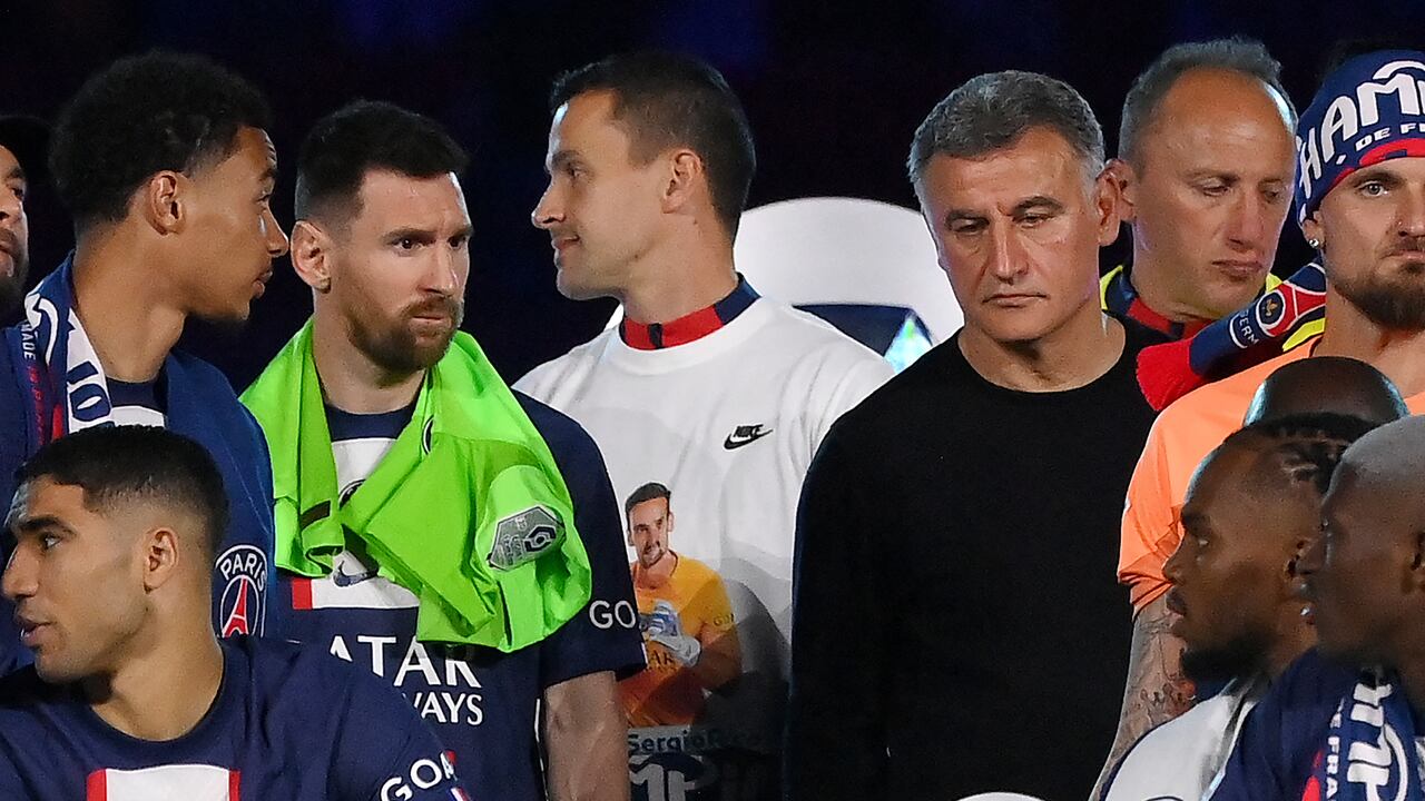 Paris Saint-Germain's Argentinian forward Lionel Messi (2nd L) and Paris Saint-Germain's French head coach Christophe Galtier (2nd R) react during the 2022-2023 Ligue 1 championship trophy ceremony following the L1 football match between Paris Saint-Germain (PSG) and Clermont Foot 63 at the Parc des Princes Stadium in Paris on June 3, 2023. (Photo by FRANCK FIFE / AFP)