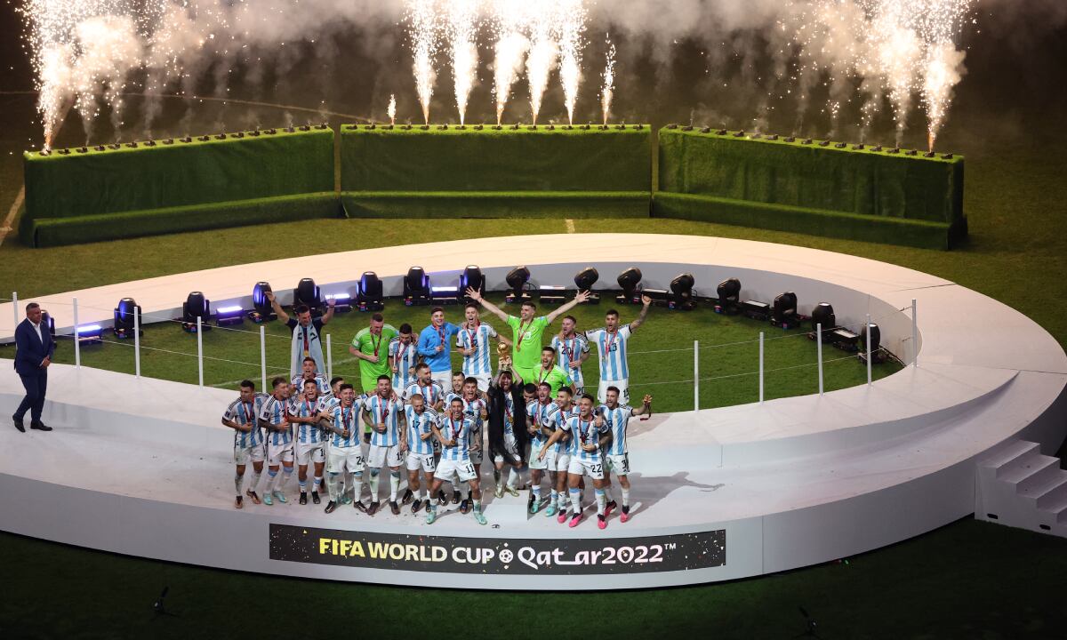 Soccer Football - FIFA World Cup Qatar 2022 - Final - Argentina v France - Lusail Stadium, Lusail, Qatar - December 18, 2022 Argentina's Lionel Messi celebrates with the trophy after winning the World Cup REUTERS/Paul Childs