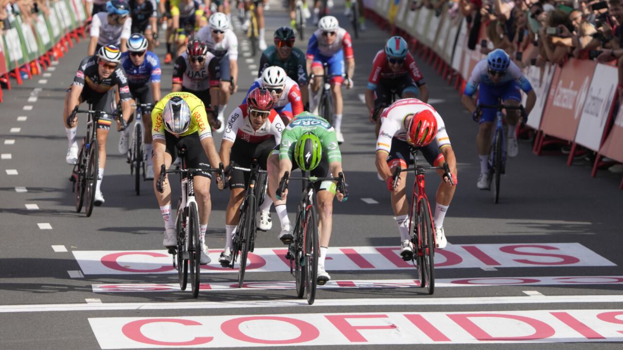 Sam Bennett of Ireland, wearing the best sprinter's green jersey, crosses the finish line ahead of Denmark's Mads Pedersen, right, to win the third stage of the Vuelta cycling race over 193.2 kilometers (120 miles) with start and finish in Breda, Netherlands, Sunday, Aug. 21, 2022. (AP/Peter Dejong)