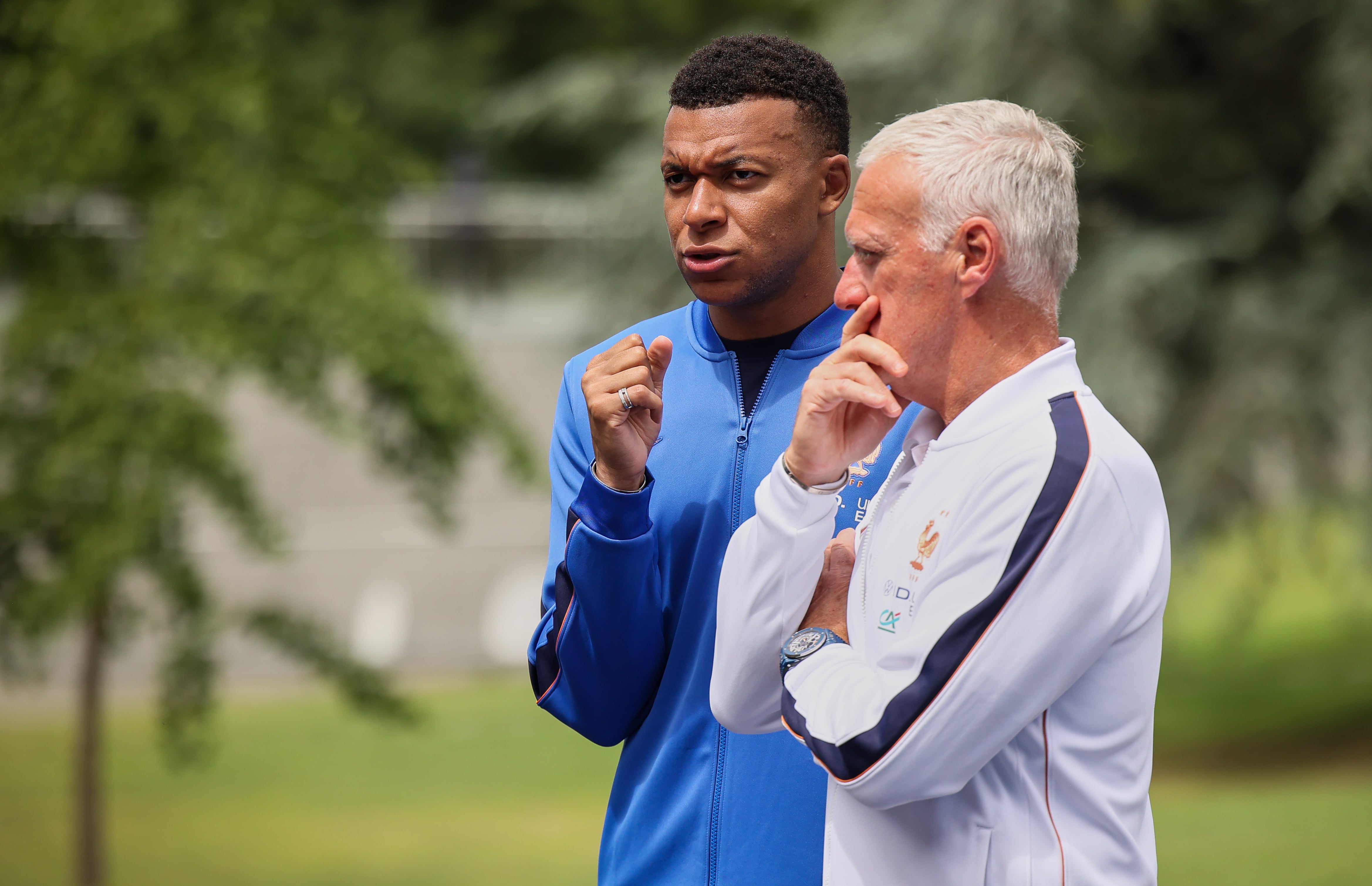 France's head coach Didier Deschamps, right, and France's Kylian Mbappe await France's President Emmanuel Macron and Brigitte Macron at the national soccer team training center in Clairefontaine, west of Paris, Tuesday, June 2, 2026, ahead of the World Cup. (AP Photo/Thomas Padilla, Pool)