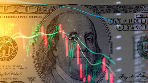 One hundred dollar bill on the background of  stock charts. Economic crisis.