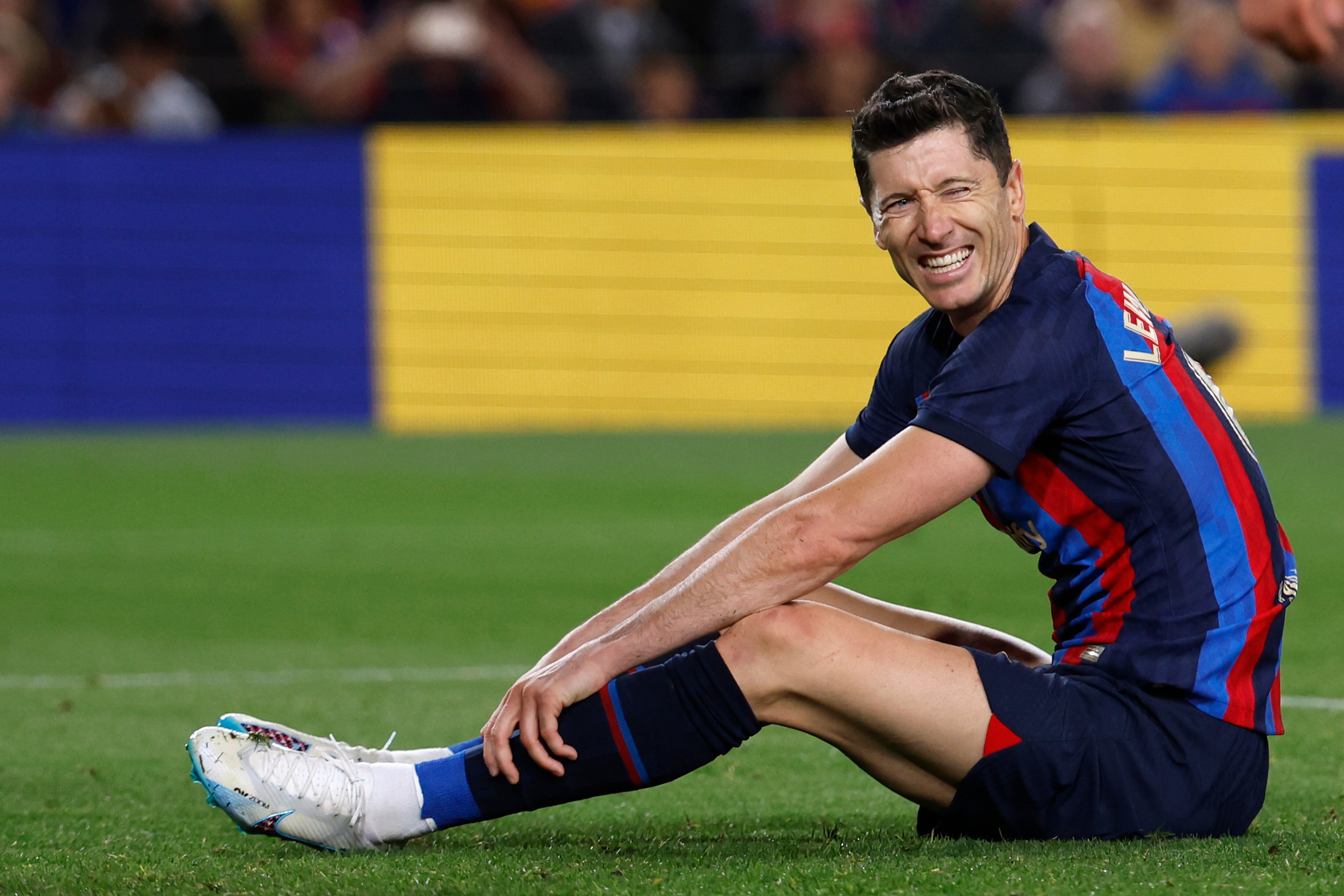 Barcelona's Robert Lewandowski reacts after missing a scoring chance during a Spanish La Liga soccer match between Barcelona and Girona at the Camp Nou stadium in Barcelona, Spain, Monday, April 10, 2023. (AP Photo/Joan Monfort)