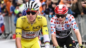 UAE Team Emirates - XRG team's Slovenian rider Tadej Pogacar wearing the overall leader's yellow jersey and Team Visma - Lease a bike team's Danish rider Jonas Vingegaard wearing the best climber's polka dot (dotted) jersey cycle in the final ascent of La Plagne during the 19th stage of the 112th edition of the Tour de France cycling race, 93.1 km between Albertville and La Plagne, in the French Alps, on July 25, 2025. The 19th stage of the Tour de France was shorted from its initial 129.9 km route, bypassing the Col des Saisies where an outbreak of nodular dermatitis in a herd of cattle was discovered, prompting organizers to modify the race route. (Photo by Anne-Christine POUJOULAT / AFP)