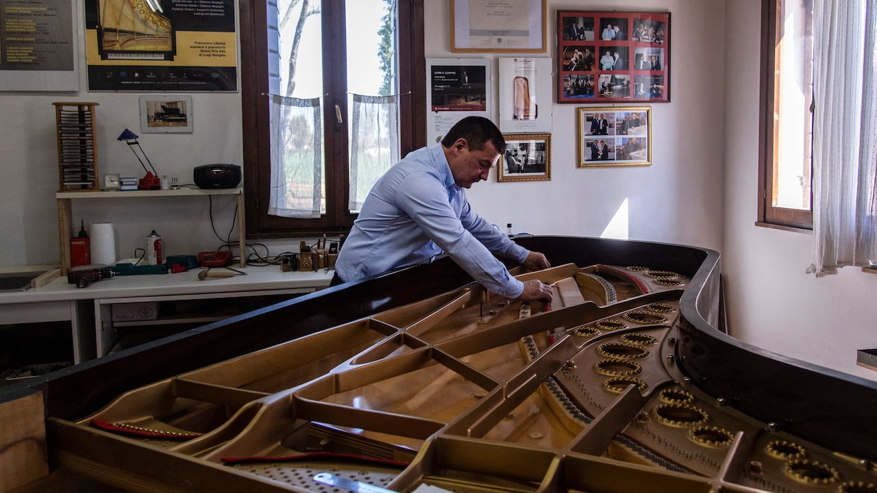 Italian piano craftsman Luigi Borgato works in his workshop in Borgo Veneto, near Padua on April 8, 2021. - Italian craftsman Luigi Borgato grew his business into a prestigious brand capable of attracting buyers from all over the world, until the coronavirus pandemic abruptly put a halt to it all. (Photo by MARCO BERTORELLO / AFP)