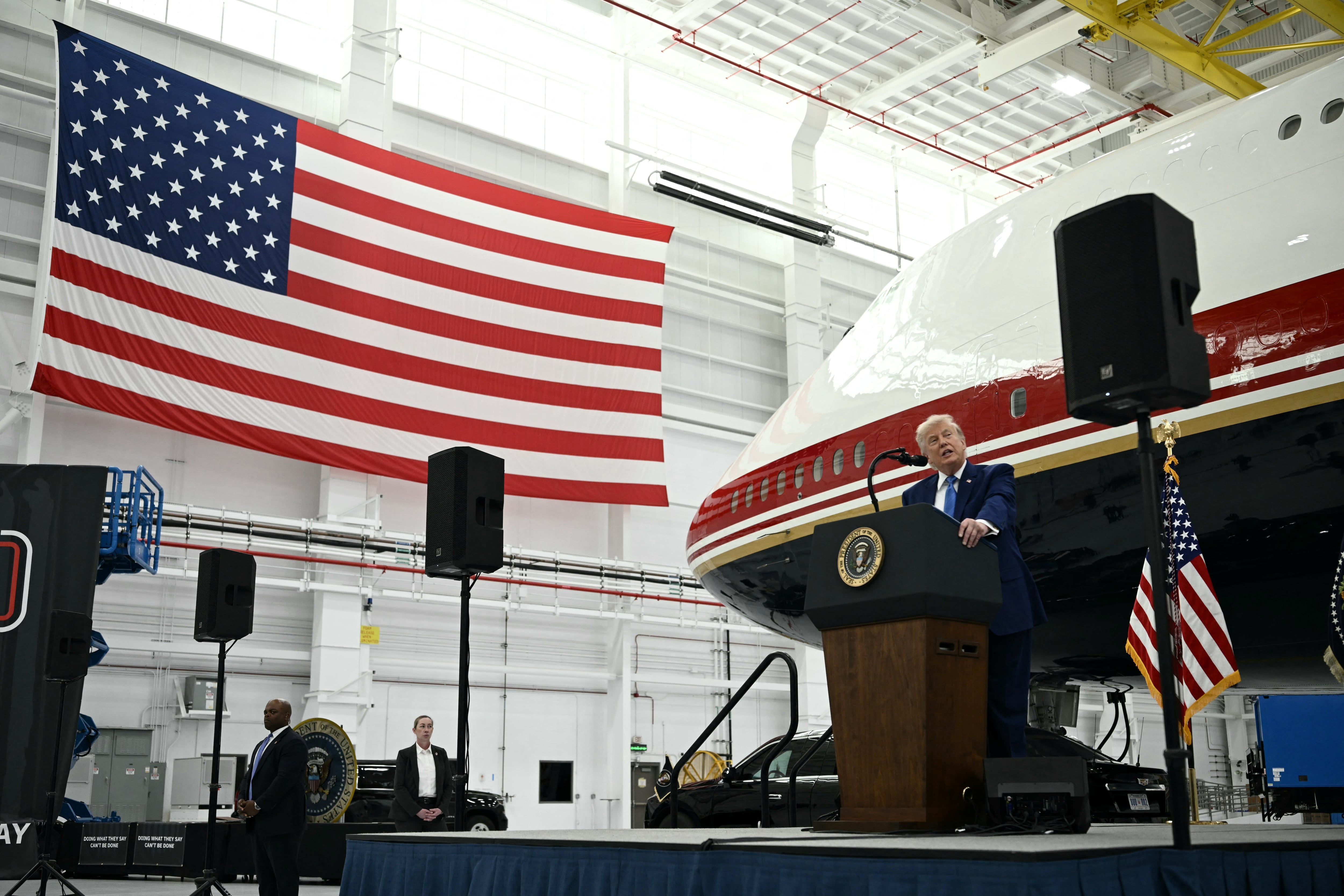 US President Donald Trump speaks in front of the new Air Force One, gifted to him by Qatar, in a hangar at Joint Base Andrews in Maryland on June 19, 2026. White House officials bade farewell on June 18, 2026 to one of the two jets that have been used to transport US presidents for more than 30 years. The goodbye messages fueled speculation that a Boeing 747 controversially gifted to President Donald Trump by the Gulf emirate of Qatar is now due to enter service. Trump will be heading to Joint Base Andrews before spending the weekend at Camp David. (Photo by Brendan SMIALOWSKI / AFP)
