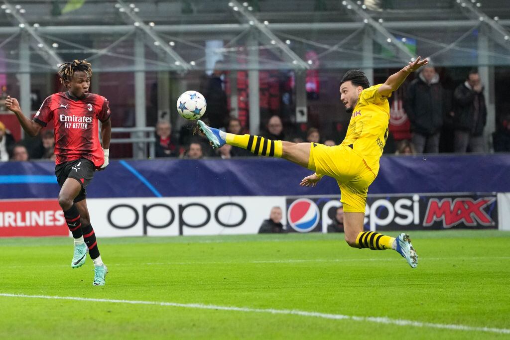 MILAN, ITALY - NOVEMBER 28: Ramy Bensebaini of Dortmund (R) against Samuel Chukwueze of Milan (L) during the UEFA Champions League Group Stage match between AC Milan and Borussia Dortmund at Stadio Giuseppe Meazza on November 28, 2023 in Milan, Italy. (Photo by Jari Pestelacci/Eurasia Sport Images/Getty Images)