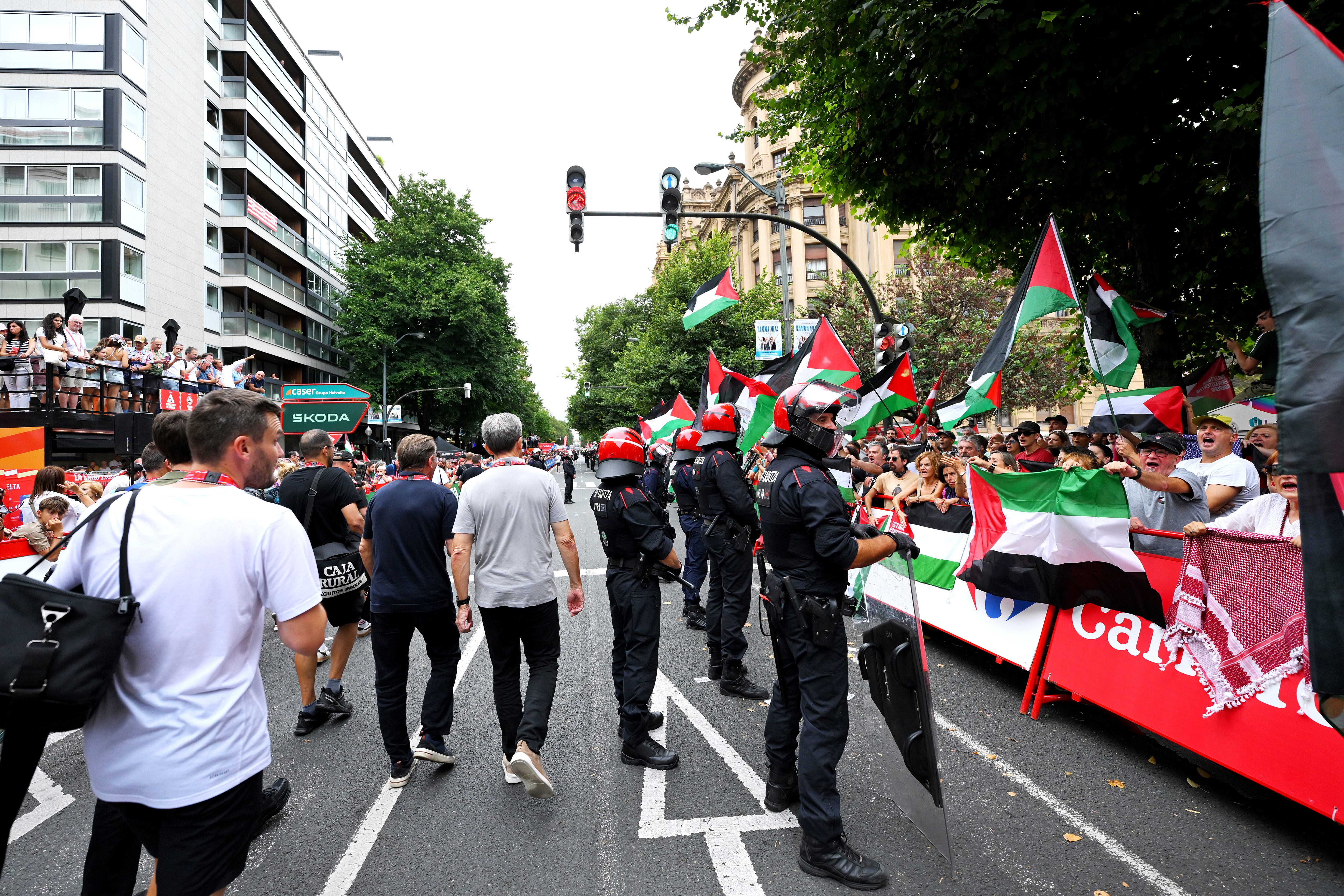 BILBAO, SPAIN - SEPTEMBER 03: Pro-Palestinian protesters at the finish line watched by the police (Ertzaina) during the La Vuelta - 80th Tour of Spain 2025, Stage 11 a 157.4km stage from Bilbao to Bilbao / Due to incidents at the finish line, the official times for the GC were taken at 3km from the finish line, there was no stage winner / #UCIWT / on September 03, 2025 in Bilbao, Spain. (Photo by Tim de Waele/Getty Images)